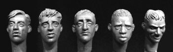 5 heads with hair, 1 African, 4 Europeans